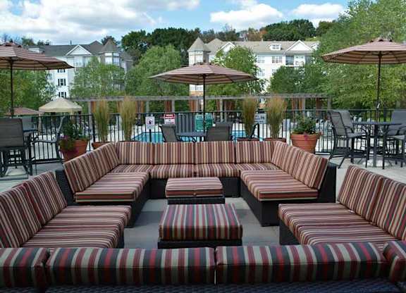 a patio with couches and tables and umbrellas at Riverview Landing @ Valley Forge, Eagleville