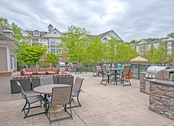 a patio with tables and chairs and a grill at Riverview Landing @ Valley Forge, Eagleville, 19403