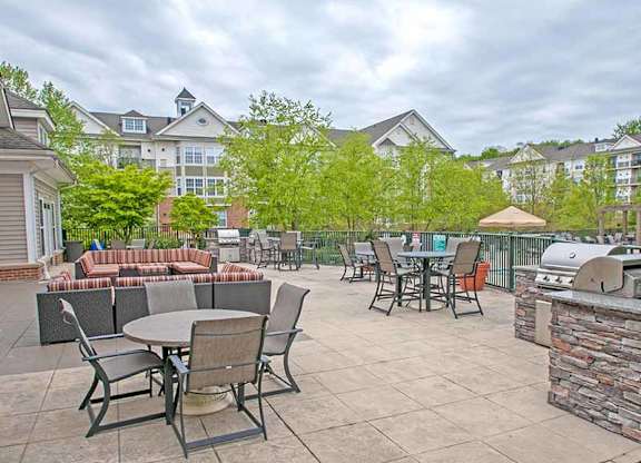 a patio with tables and chairs and a grill at Riverview Landing @ Valley Forge, Pennsylvania