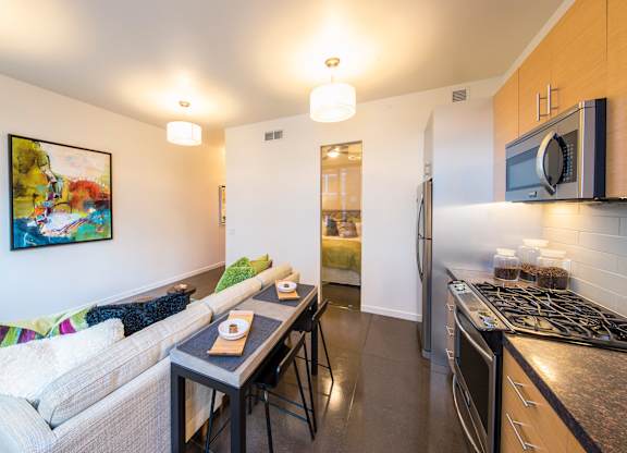 A kitchen with a stove top oven and a microwave above it.