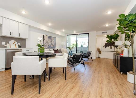 A modern kitchen with a dining table and chairs.