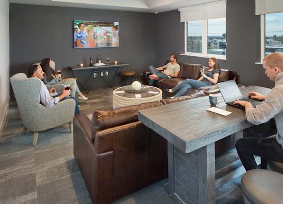 A group of people are sitting in a modern lounge area.