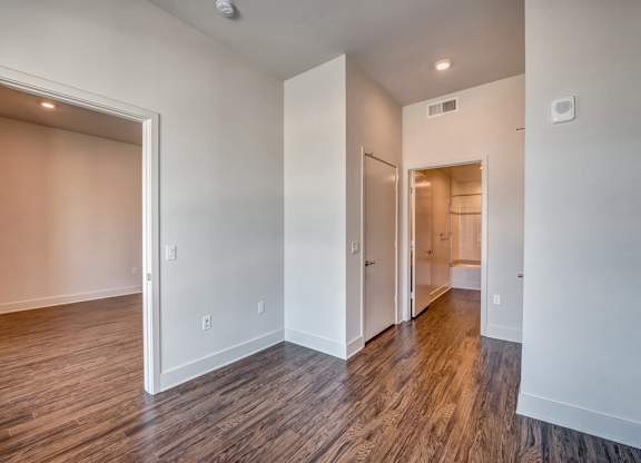 A room with wood flooring and white walls.