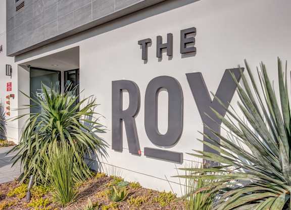 A large sign on a building that says "THE ROY".