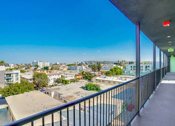 A balcony with a view of a cityscape.