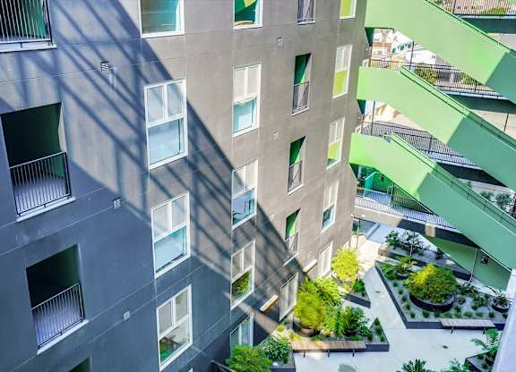 A modern building with a green staircase on the right side.