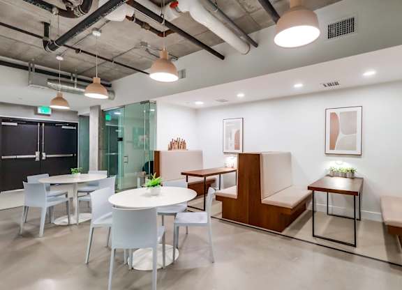 A modern office space with a glass wall and a blackboard.