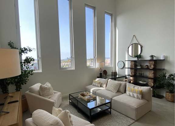A living room with a couch, chair, and coffee table.