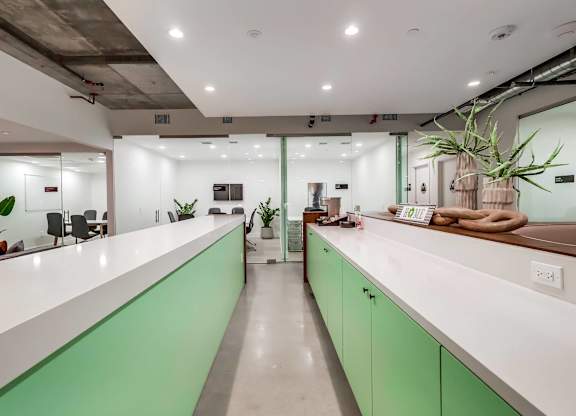 A modern office with green and white counters.
