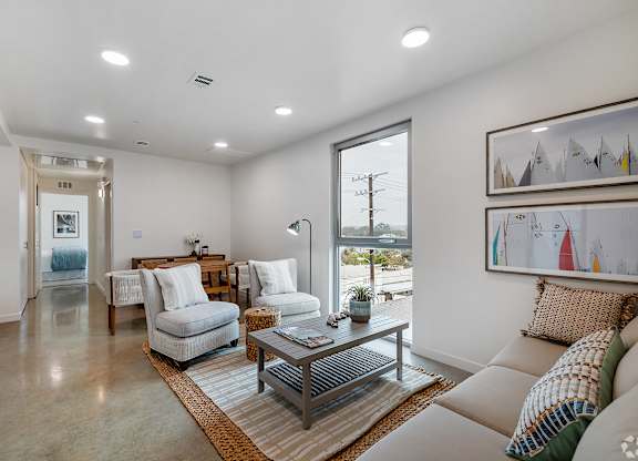 A modern living room with a large window and a view of the outdoors.