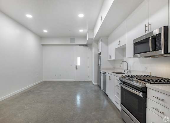 A kitchen with white cabinets and stainless steel appliances.