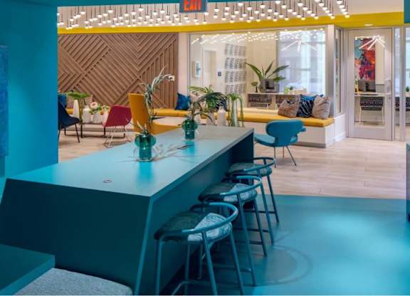 A brightly lit room with a bar and seating area.