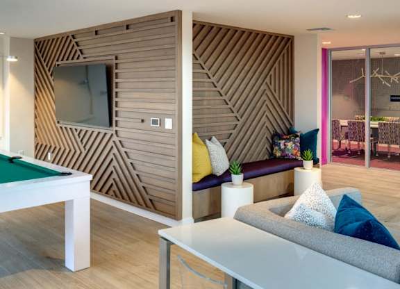 A room with a pool table and a couch.