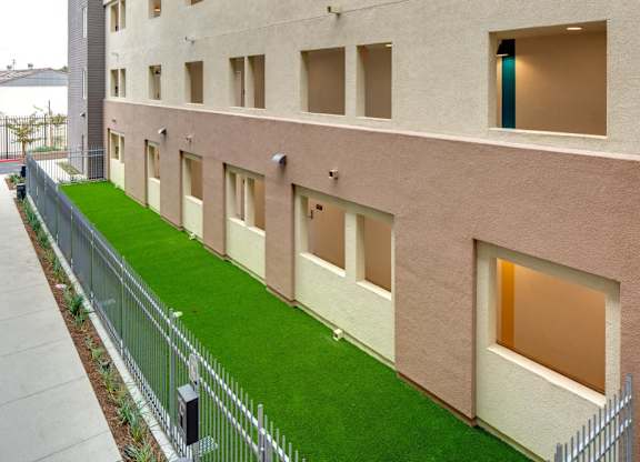 A building with a green lawn in front.