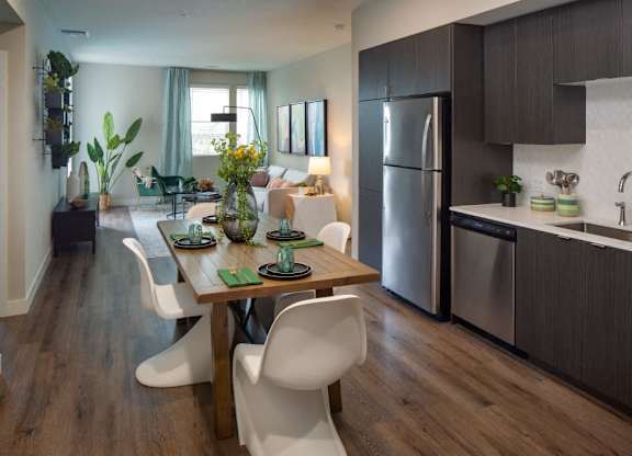 A modern kitchen with a dining table and chairs.