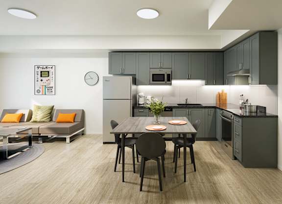 A modern kitchen with a dining table set for two.
