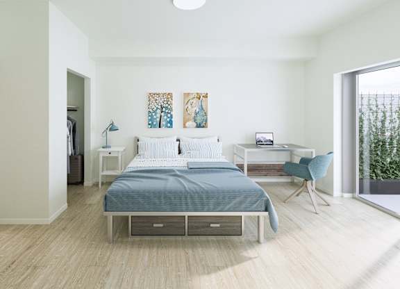 A bedroom with a bed, nightstand, and chair.