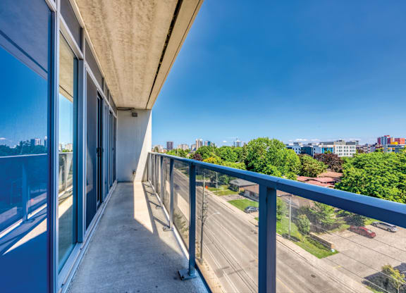 A balcony with a view of a highway and buildings.