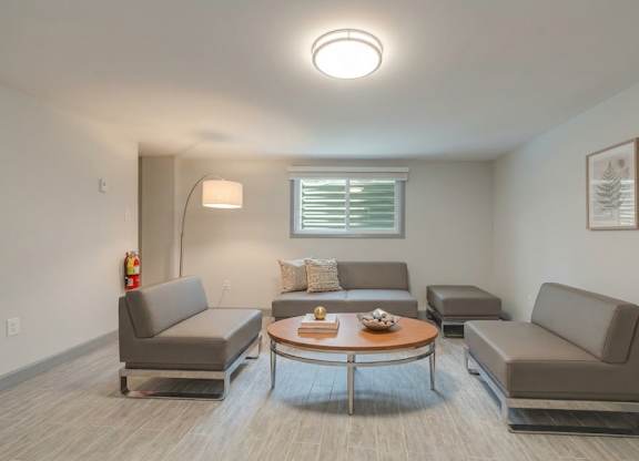 A living room with grey couches and a coffee table.
