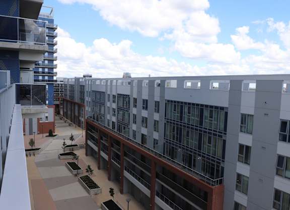 A view of a courtyard with a building in the background.