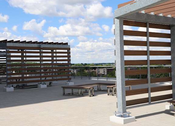 A wooden structure with slats on the side and a table in front.