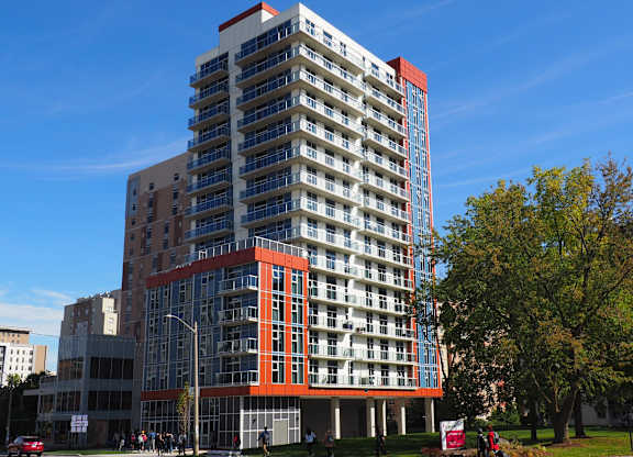 a tall building in a city with a blue sky in the background