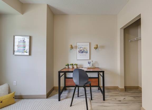 A room with a desk and chair in it.