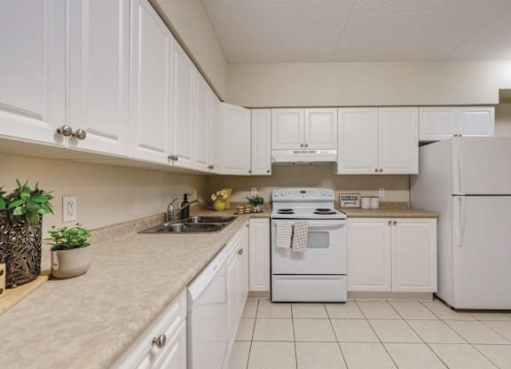 A kitchen with white appliances and cabinets.