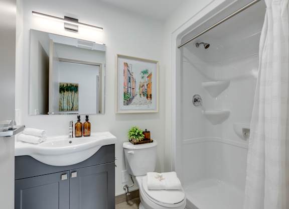 A bathroom with a white toilet and a white sink.