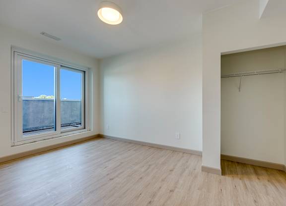 Empty room with a window and a door.