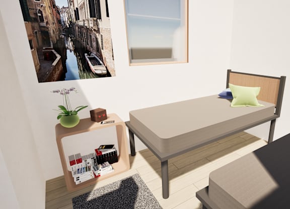 A bedroom with a bed, nightstand, and a picture of a canal in Venice.