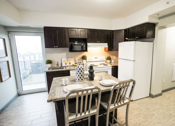 an open kitchen and dining area with a table and chairs