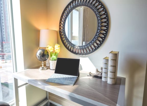 a laptop computer sitting on a desk in a home office