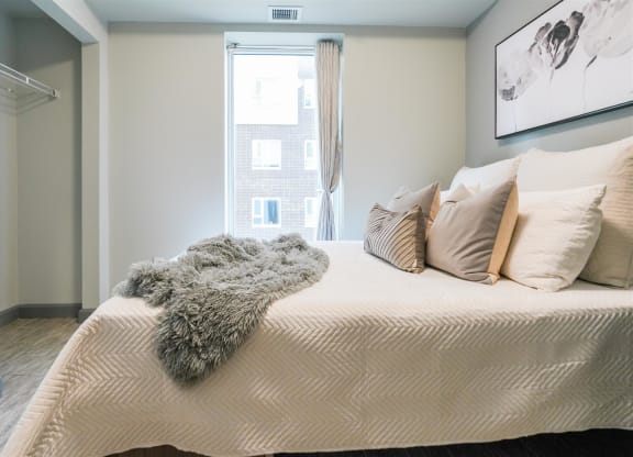 a bedroom with a large bed and a window