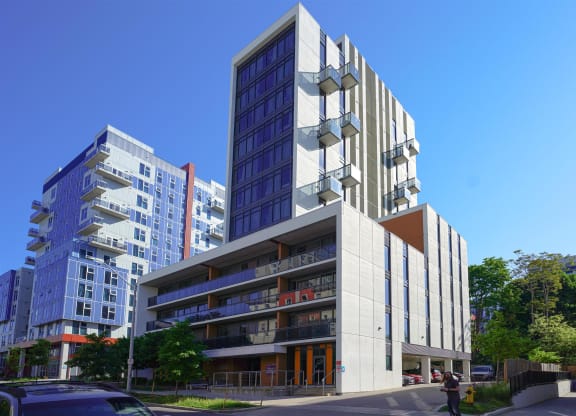 a tall building on a city street with tall buildings