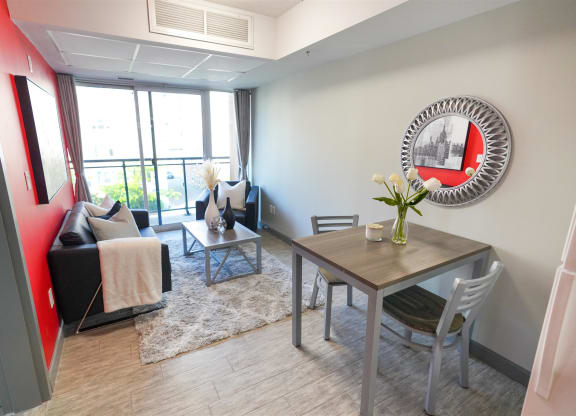 a living room with a table and chairs and a mirror