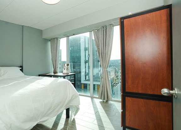 a bedroom with a bed and a door to a balcony