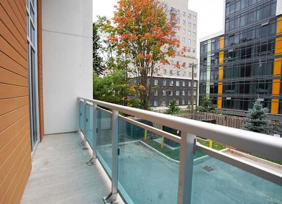 a balcony with a pool and a building in the background