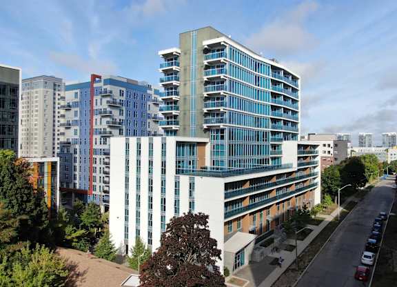 an aerial view of an office building with other buildings in the background