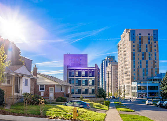 A sunny day in a residential area with a purple building in the middle.
