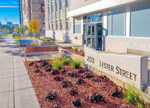 A street sign for Lester Street is in front of a building.