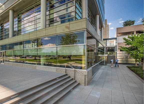 A modern building with glass windows and a sign that reads