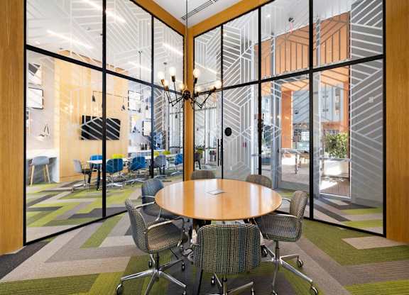a conference room with a wooden table and chairs