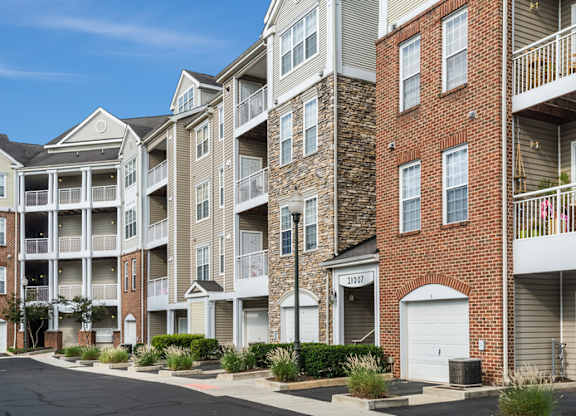 an apartment building with brick exterior and white balconies
