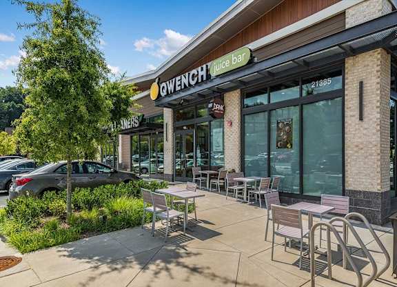 a patio outside of a restaurant with tables and chairs