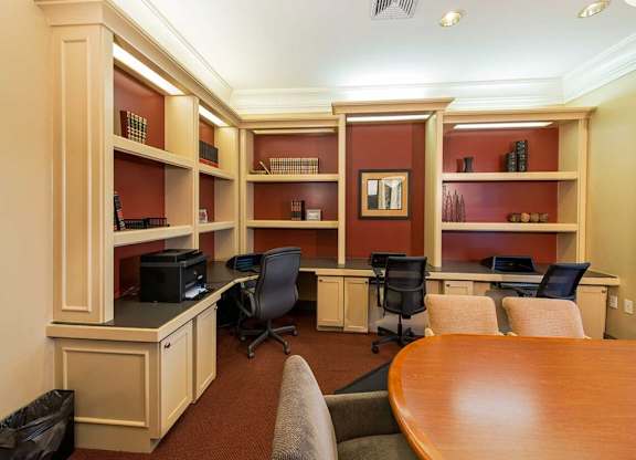 a conference room with two desks and a table and chairs