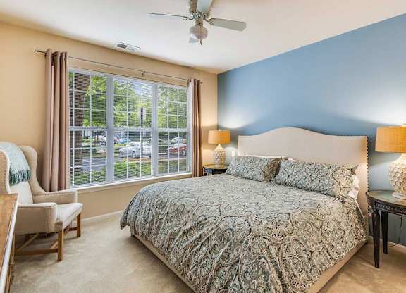 a bedroom with a bed and a ceiling fan