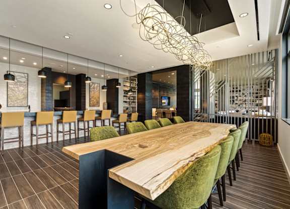 a dining room with a wooden table and chairs