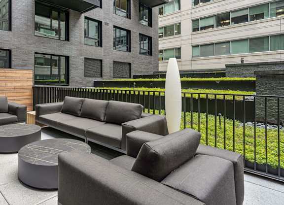 the lobby of a building with couches and tables