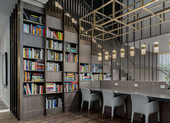 1000 South Capitol's lobby library with individual seating and books on shelves.